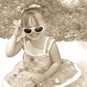 Little girl making face while wearing sunglasses
