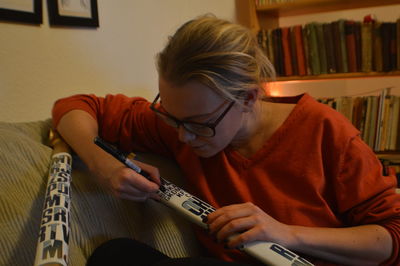 Woman writing on metal at home
