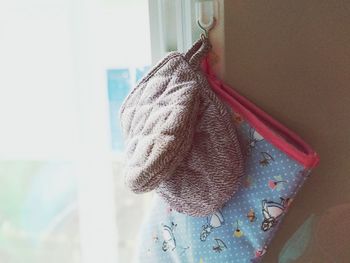 Close-up of clothes hanging on window at home