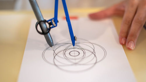 Cropped hand of scientist examining chemical on table