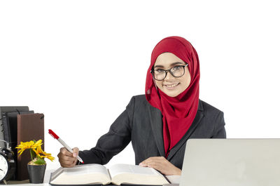 Portrait of smiling young man using laptop