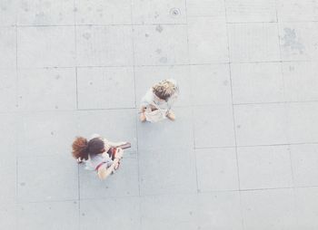 High angle view of woman sitting with flower