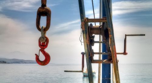 Close-up of clothes hanging by sea against sky