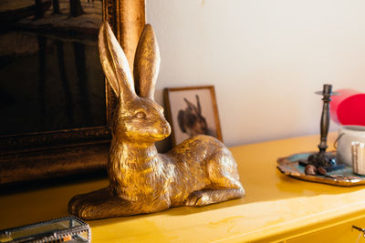 Close-up of animal statue on table at home