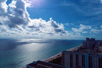 Panoramic view of sea and buildings against sky