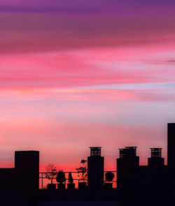 Silhouette buildings against sky during sunset