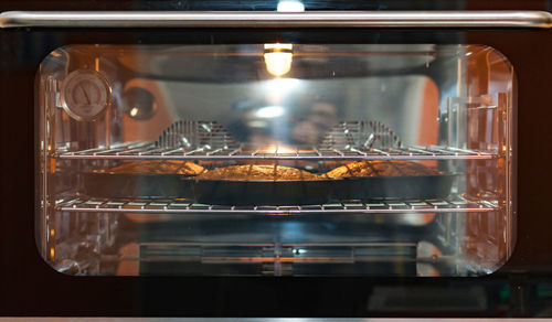 Three carrot cakes in the oven, ambient light.