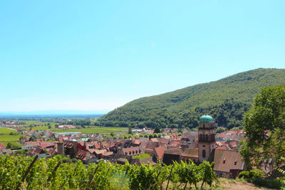 Townscape against clear blue sky