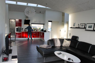 Rear view of man cooking in kitchen at home