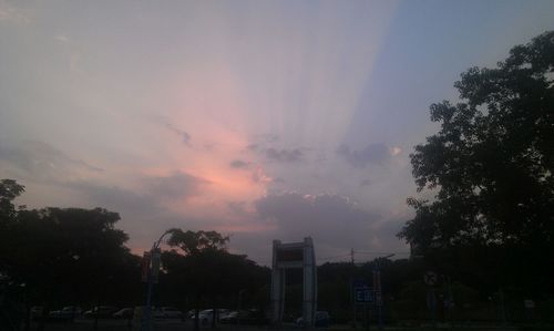 Buildings against cloudy sky at sunset