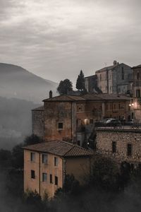 Buildings in town against sky