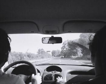 Cropped image of man driving car