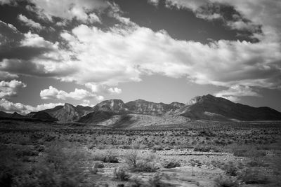 Scenic view of mountains against cloudy sky