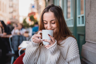 Young woman holding coffee cup