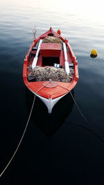 Close-up of boat sailing on sea against sky