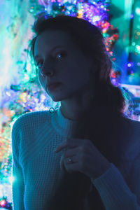 Portrait photo of a girl on a background of colorful garlands