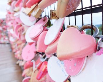 Pink love locks on railing