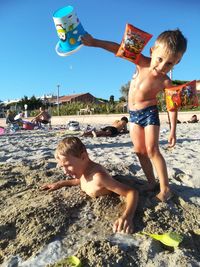 Happy siblings lying on land