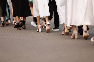 Low section of people walking on road