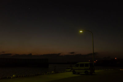 View of illuminated street light against sky at night