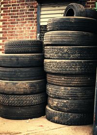 Stack of wood against brick wall