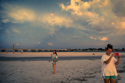 Full length of woman standing on beach