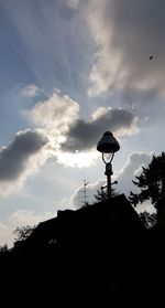 Low angle view of street light and building against sky