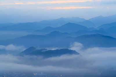 Scenic view of mountains against cloudy sky