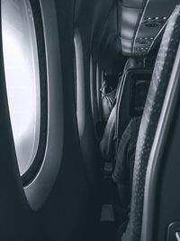 Midsection of man sitting in airplane