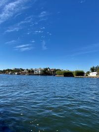 Scenic view of lake against blue sky