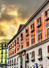 Low angle view of buildings against sky during sunset