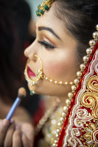 Close-up of young woman blowing roses