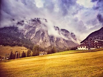 Scenic view of field and mountains against sky