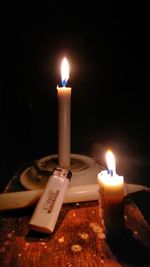 Close-up of lit candles on table