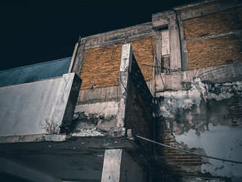 Low angle view of old building against sky at night