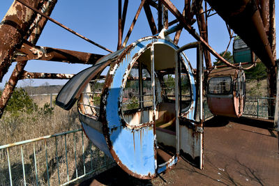 Abandoned boat moored against sky