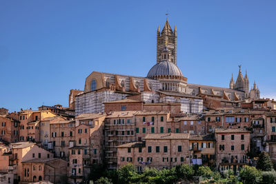 Low angle view of buildings against blue sky