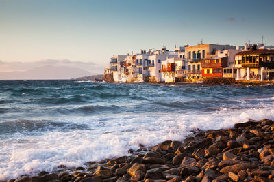 Scenic view of sea and buildings against sky