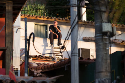 Young man jumping outside building