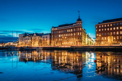 Reflection of buildings in water at night