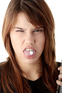 Close-up portrait of beautiful woman against white background