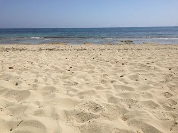 Scenic view of beach against clear sky