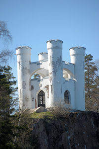 Low angle view of old building against clear blue sky