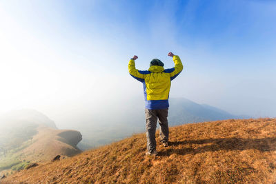 Rear view of man standing on landscape