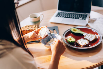 Young modern woman taking care of herself makes a healthy breakfast.