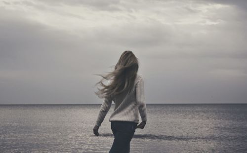 Silhouette of woman standing on beach