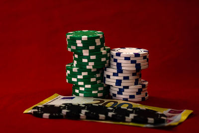 Stack of objects on table against red background
