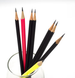 Close-up of colored pencils against white background