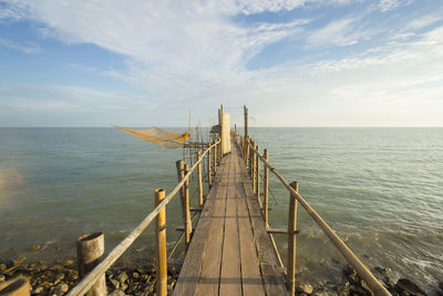 Pier over sea against sky