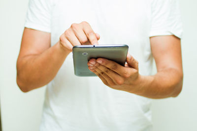 Midsection of man using mobile phone